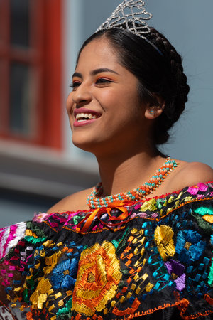 Matamoros, Tamaulipas, Mexico - November 20, 2019: The Mexican Revolution Day Parade, Young Beaty queen wearing a mexican traditional dress, waves and smiles to the spectatorsのeditorial素材