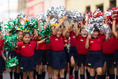 Matamoros, Tamaulipas, Mexico - November 20, 2019: The Mexican Revolution Day Parade, School girls using Pom-poms, cheering during the paradeのeditorial素材