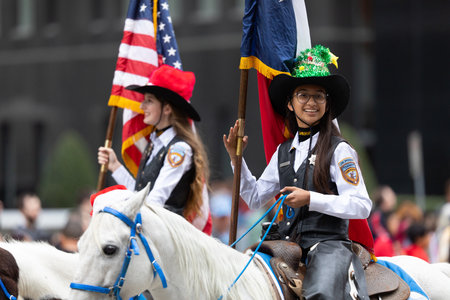 Houston, Texas, USA - November 28, 2019: H-E-B Thanksgiving Day Parade, Group of Mounted Police Officers riding horses, waving at people during the paradeのeditorial素材