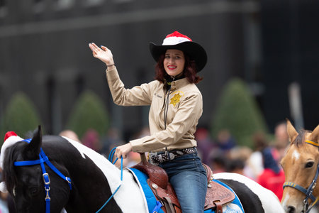 Houston, Texas, USA - November 28, 2019: H-E-B Thanksgiving Day Parade, Group of Mounted Police Officers riding horses, waving at people during the paradeのeditorial素材