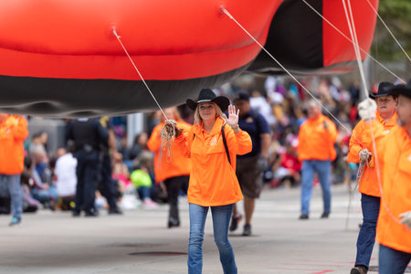 Houston, Texas, USA - November 28, 2019: H-E-B Thanksgiving Day Parade, Group of people carrying a...