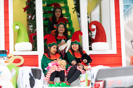 Houston, Texas, USA - November 28, 2019: H-E-B Thanksgiving Day Parade, Santa's elf helpers, on a float, waving and smiling at spectators during the paradeのeditorial素材
