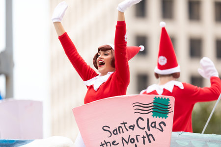 Houston, Texas, USA - November 28, 2019: H-E-B Thanksgiving Day Parade, Santa's elf helpers, on a float, waving and smiling at spectators during the paradeのeditorial素材