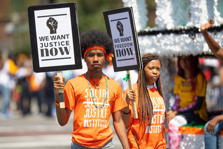 Chicago, Illinois, USA - August 8, 2019: The Bud Billiken Parade, Man and woman holding signs promoting Social Justice and Freedomのeditorial素材