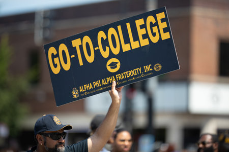 Chicago, Illinois, USA - August 8, 2019: The Bud Billiken Parade, men holding signs promoting...