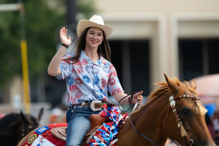 Arlington, Texas, USA - July 4, 2019: Arlington 4th of July Parade, Young woman riding a horse down route at the paradeのeditorial素材