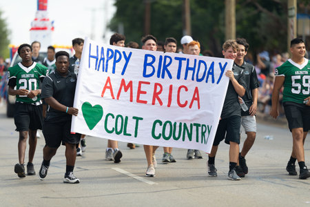 Arlington, Texas, USA - July 4, 2019: Arlington 4th of July Parade, Members of Arlington High School, Colts football team at the paradeのeditorial素材