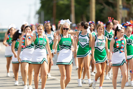 Arlington, Texas, USA - July 4, 2019: Arlington 4th of July Parade, Members of Arlington High School, Cheerleaders, walking down Center street during the paradeのeditorial素材