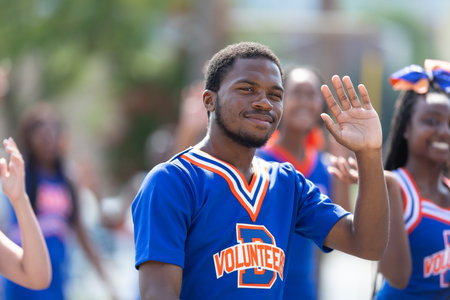 Arlington, Texas, USA - July 4, 2019: Arlington 4th of July Parade, Members of James Bowie High School Volunteers cheerleader team, walking down center streetのeditorial素材