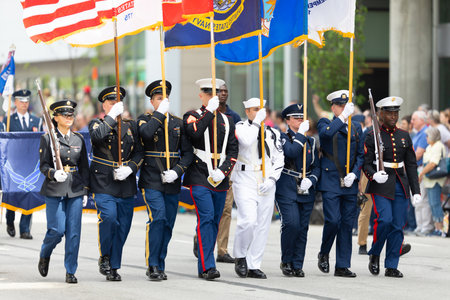 Indianapolis, Indiana, USA - May 25, 2019: Indy 500 Parade, Members of the United States military escorting the American flag down Pennsylvania Streetのeditorial素材