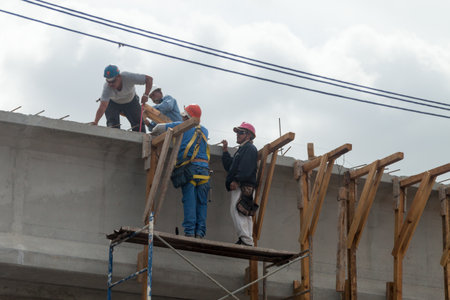 Matamoros, Tamaulipas, Mexico - February 27, 2013: Mexican bridge construction crew on a scaffold,...
