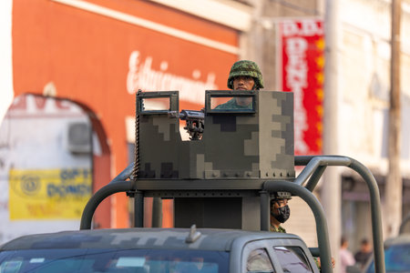 Matamoros, Tamaulipas, Mexico - September 16, 2022: Desfile 16 de Septiembre, Mexican Army Chevrolet truck with a soldier handling a machine gun on a turretのeditorial素材