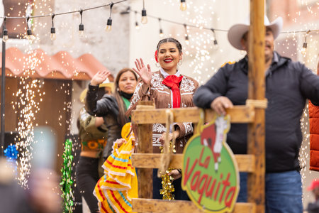 Brownsville, Texas, USA - February 26, 2022: Charro Days Grand International Parade, woman riding a float wearing traditional mexican clothingのeditorial素材
