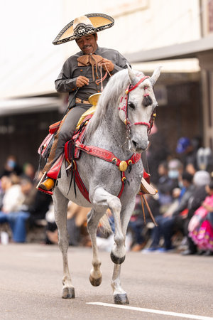 Brownsville, Texas, USA - February 26, 2022: Charro Days Grand International Parade, Members of Charros La Herradura wearing traditional Charro clothing, riding horses at the paradeのeditorial素材