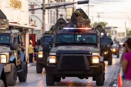 Matamoros, Tamaulipas, Mexico - September 16, 2022: Desfile 16 de Septiembre, Mexican Army soldier handling a heavy machine gun turret on an armored personel carrierのeditorial素材
