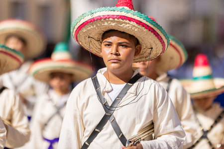 Matamoros, Tamaulipas, Mexico - November 26, 2022: The Desfile del 20 de Noviembre, Members of the Escuela Secundaria General No 7 marching band, wearing traditional clothing, performing at the paradeのeditorial素材
