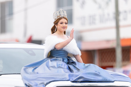 Valle Hermoso, Tamaulipas, Mexico - March 18, 2023: City Anniversary Parade, Beauty queen wearing her crown and a traditional dress, riding a vehicle during the paradeのeditorial素材