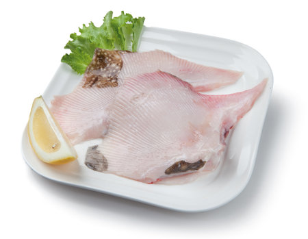 Fish composition on plate with lemon and salad