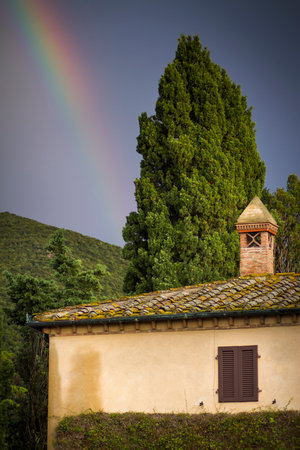 Querceto or Castle of Querceto is a fraction of the town of Montecatini Val di Cecina in the province of Pisa, located on the slopes of Mount Aneo, on a hilly outcrop overlooking the valley of Cecina and the Sterza river. View with rainbowのeditorial素材