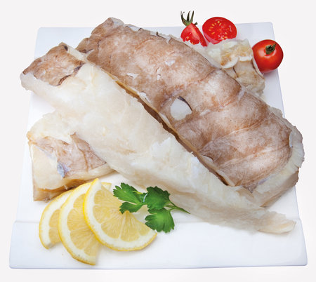 Fish composition with vegetables, lemon, onion and tomatoes with salt cod
