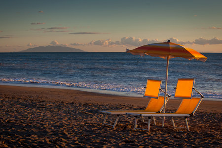 Backlight on the sea, umbrellas and deck chairs from Marina di Bibbona, Tuscanyの写真素材