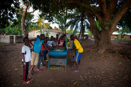 Yongoro, Sierra Leone - June 01, 2013: West Africa, the village of Yongoro in front of Freetown, children play to football with foosballのeditorial素材