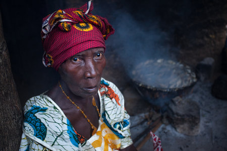 Yongoro, Sierra Leone - June 02, 2013: West Africa, the village of Yongoro in front of Freetown, while woman is cookingのeditorial素材