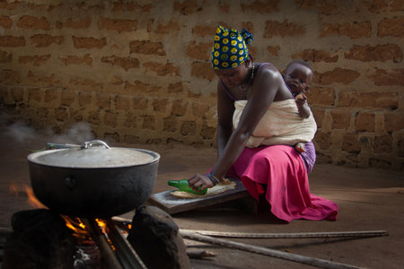 Yongoro, Sierra Leone - June 03, 2013: West Africa, the village of Yongoro in front of Freetown,in front of his house preparing food for the familyのeditorial素材