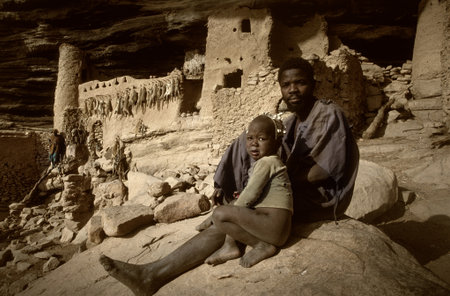 Gommo, Mali, Africa - January 26, 1992: Dogon village, typical mud buildings with animist temple and barns for cerealsのeditorial素材
