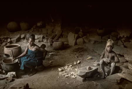 Gommo, Mali, Africa - January 26, 1992: Dogon village, typical mud buildings with animist temple and barns for cereals, food preparationのeditorial素材