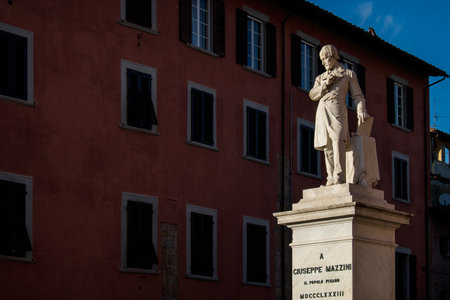 Giuseppe Mazzini statue and the sky in Pisa, Tuscany, Italyの写真素材
