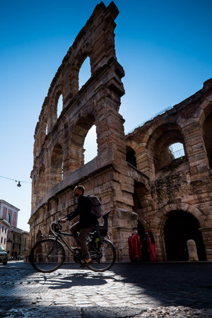 VERONA, Italy - April 04, 2017: View of Arena historical building in Verona, one of the most popular cities of Veneto, backlight of biker, Italyのeditorial素材