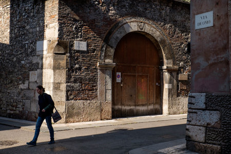 VERONA, Italy - April 04, 2017: Tourists crossing the street Via Duomo leading to the Santa Maria Cathedral Matricolareのeditorial素材