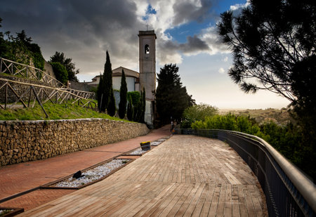 Montescudaio, Pisa, Tuscany, Italy, Panorama at sunset of the tower and church from the Castle Squareのeditorial素材