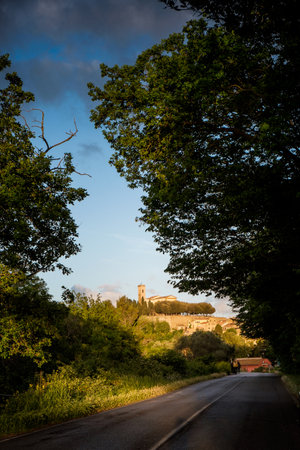 Montescudaio, Pisa, Tuscany, Italy, Views of the ancient village with the civic tower and the church from the Provincial Street of Poggettoの写真素材
