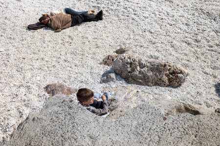 MARINA DI PISA, ITALY - Avril 24, 2017: View of the sea and the beach of white pebbles, people take...