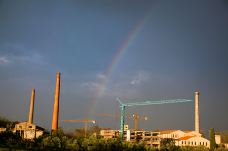 Cecina, Tuscany, the Rainbow after the storm in background the old brick factory today not workingの写真素材