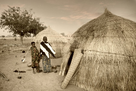 Mali, West Africa - January 25, 1992: Peul village and typical mud buildings with barns for cereals, Fulani popolationsのeditorial素材