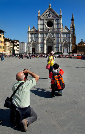 Florence, Tuscany - April 09, 2011 - the Basilica of Santa Croce with tourists who photograph itのeditorial素材