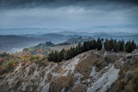 Chiusure, Siena, Tuscany - Novembre 12, 2017: Autumnal trekking in the province of Siena, from Buonconvento village along the Cassia Road, to the confluence of the rivers Arbia and Ombrone then along the historical Via Francigena and the village of Chiusure we got the Monte Oliveto Maggiore Abbeyの写真素材