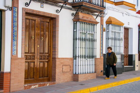 Olvera, CÃ¡diz province, Andalusia, Spain - March 25, 2008: Olvera is one of the White Towns or Pueblos Blancos of Andalusia, woman walks in calle Llianaのeditorial素材