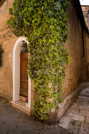 SERRE di RAPOLANO, TUSCANY, Italy - April 25, 2018: trekking in Serre di Rapolano known for the travertine quarries, but from the medieval heart, Siena. Typical house with climbing ivyのeditorial素材