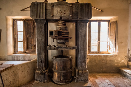 ASCIANO, TUSCANY, Italy - April 25, 2018: trekking, Asciano with ravines, farms in a harsh landscape, arrived in Serre di Rapolano known for the travertine quarries, but from the medieval heart. Ancient stone mill of 1870, is located on Poggio Pinci, Sienのeditorial素材