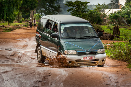 Yongoro, Sierra Leone - May 31, 2013: West Africa, the road after a storm with the holes full of...