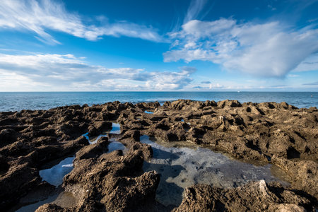 The beach and the sea in the stretch that goes from cuttlefish to the port of boats of the small town of Rosignano Solvay, province of Livorno, Tuscanyの写真素材