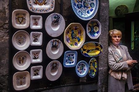 BOLSENA, ITALY - OCTOBER 21, 2001: Unknown woman ceramics vendor near the lake of Bolsena (Italy) - The medieval town with castle on Lake Bolsena, region Latium, central Italyのeditorial素材