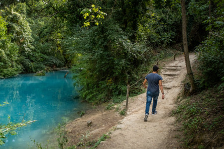 ELSA RIVER, ITALY - SEPTEMBER 15, 2019: one unknown man at Elsa river park, the trail starts in Gracciano and reaches in Colle Val dâElsa (Siena, Tuscany) the river's waters are clear and of an intense turquoise colorのeditorial素材