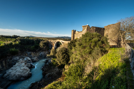 VULCI, ITALY - DECEMBER 26, 2019: The Badia bridge and castle, medieval dating back to the 13th century, an ancient Etruscan city in the territory of Canino and Montalto di Castro, in the province of Viterbo, in the Maremma of Lazio.のeditorial素材