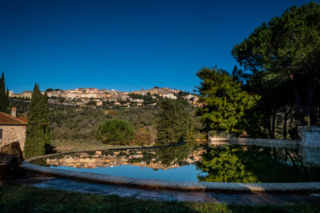 Reflection of landscape of Castagneto Carducci, in the heart of the Livorno Maremma, in the center of the Etruscan coast, trekking among the dirt roads around the medieval village, Tuscany, Italyの写真素材