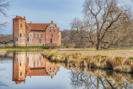 Torups Slott (Torup Castle) facade reflection on a pond water in the garden. Countryside castel in the Bokskogen area is an ancient Swedish cultural heritage and local attraction - Svedala, Swedenのeditorial素材